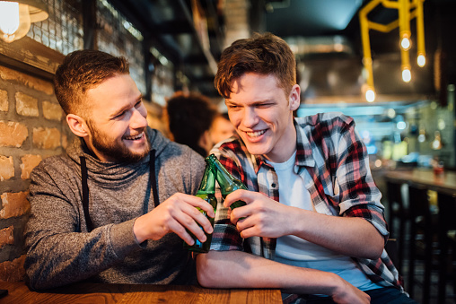 Young men drinking beer at the pub