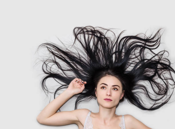 istock woman is lying on a light background with long flowing hair 1141475505