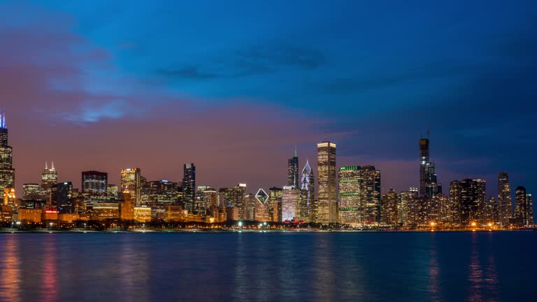 4K Time lapse of Chicago skyline panorama of Downtown Chicago with shoreline along Lake Michigan at beautiful nighttime in Chicago, Illinois, United States, Business and Modern Architecture concept