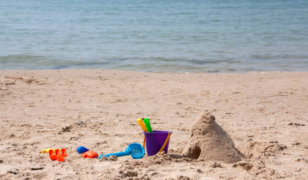 istock children's shovels in the sand on the beach 1141479232