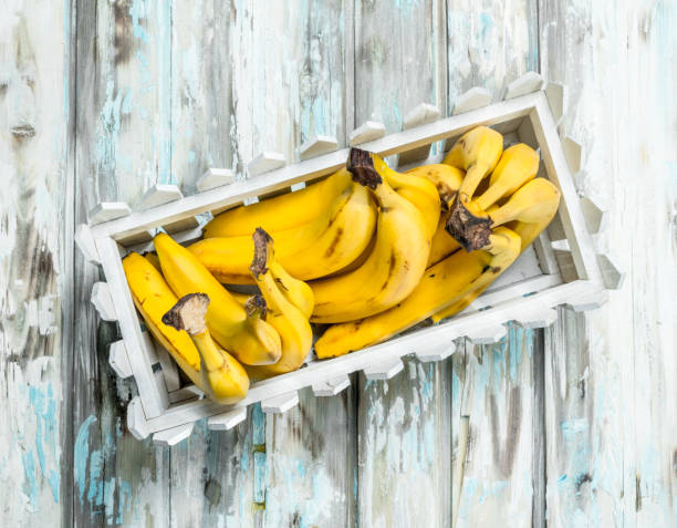 Fresh bananas in a white plastic basket.