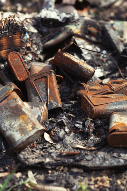 istock Burnt old rusty cans thrown away in the forest 1141479460