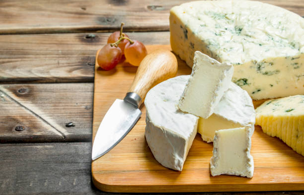 istock Blue and brie cheese on a chopping Board with a knife. 1141480103