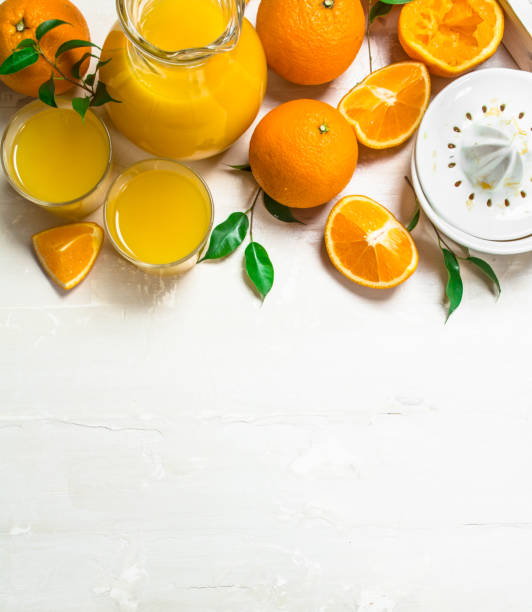 istock Orange juice in pitcher and juicer. 1141481268