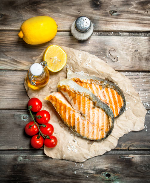 istock Grilled salmon with tomatoes and lemon. 1141481464