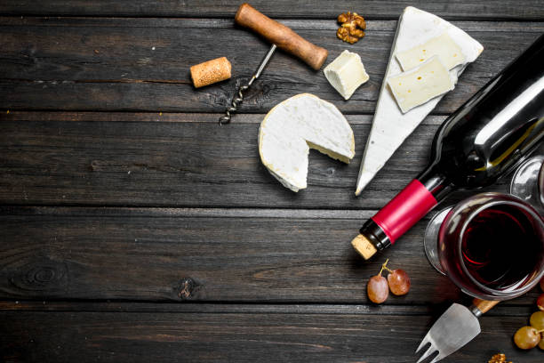 istock Brie cheese with red wine, nuts and grapes. 1141481867