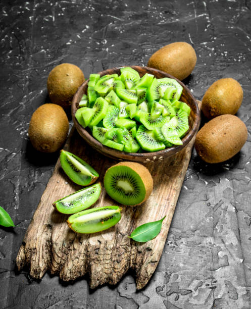istock Kiwi slices in a bowl on a cutting Board. 1141482197