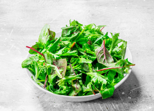 istock Healthy salad. Arugula salad in a bowl. 1141482431