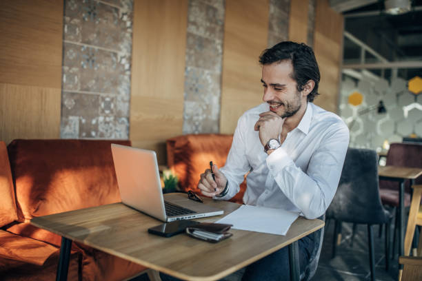 istock Businessman working on laptop in cafe 1141482582