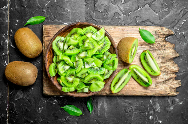 istock Kiwi slices in a bowl on a cutting Board. 1141482635