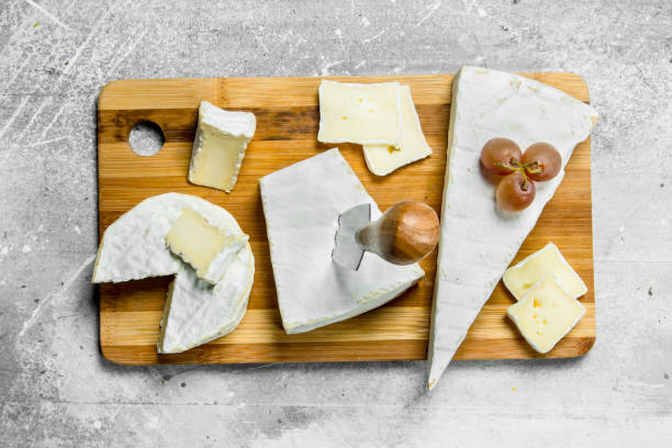 istock Brie cheese with grapes on a wooden Board. 1141482678