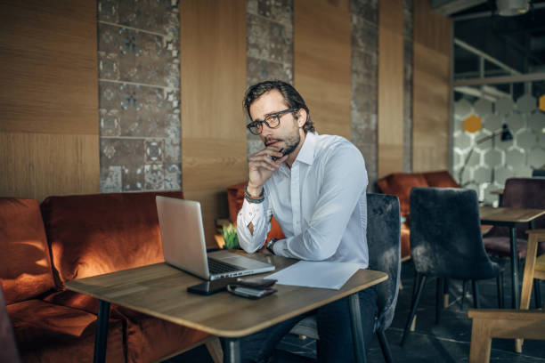 istock Businessman working on laptop in cafe 1141484258