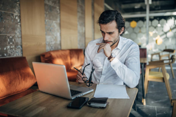 istock Businessman working on laptop in cafe 1141484286