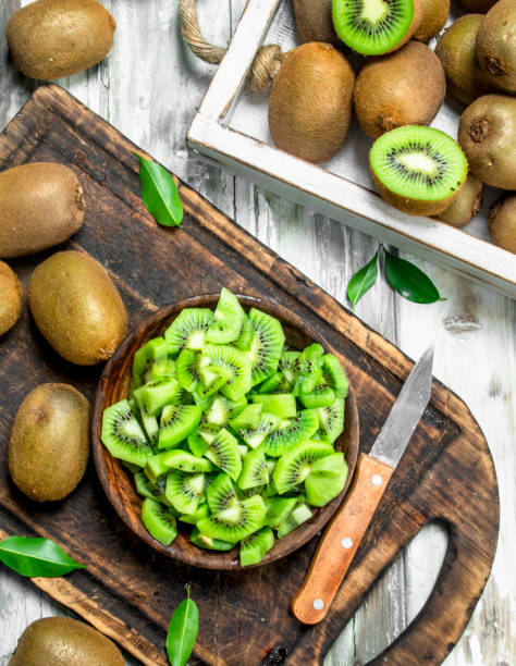 istock Kiwi slices in a bowl on a cutting Board with a knife. 1141484829