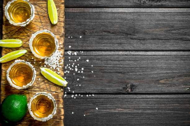 istock Tequila on a cutting Board with slices of fresh lime. 1141484987