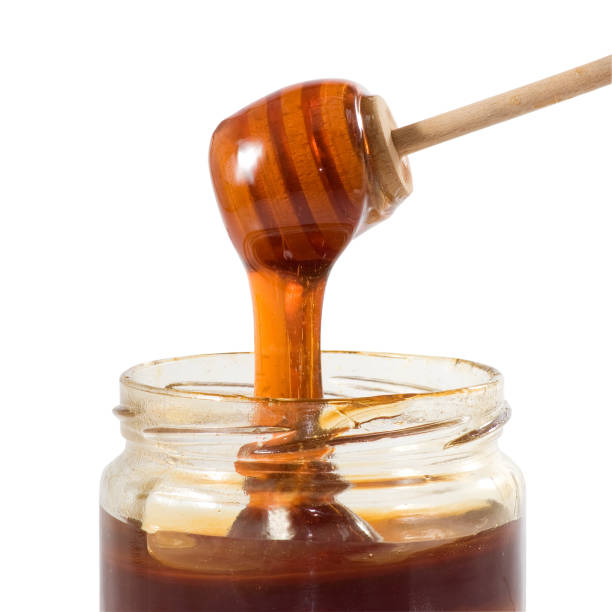 istock image of honey in a jar close up 1141486239