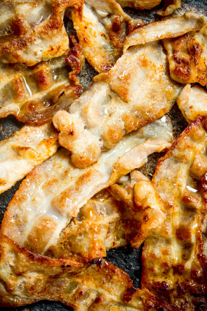 istock Fried bacon in a frying pan. 1141487189