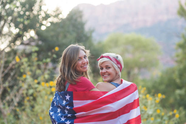 istock Two friends drape themselves in an American flag outside 1141488597