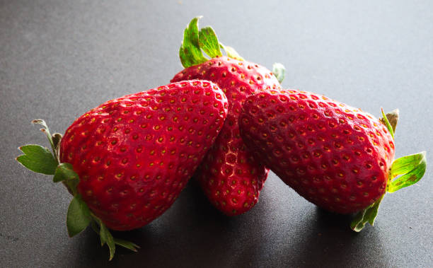 istock three red and tasty strawberries 1141488732