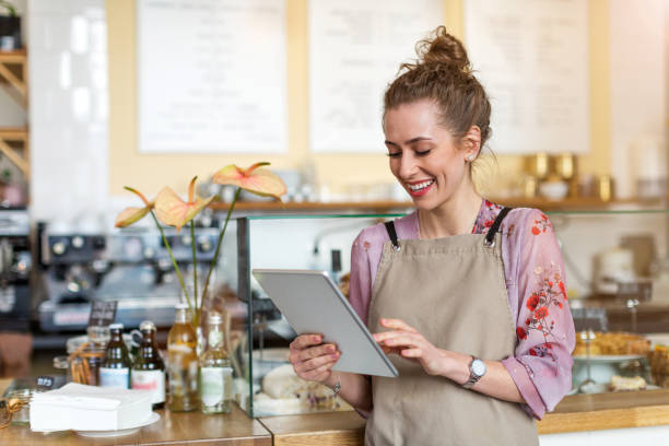 istock Young woman using digital tablet in coffee shop 1141489488