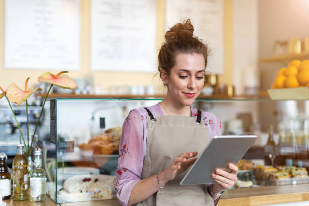 istock Young woman using digital tablet in coffee shop 1141489633