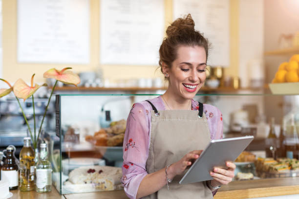 istock Young woman using digital tablet in coffee shop 1141489660