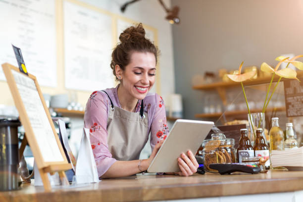 istock Young woman using digital tablet in coffee shop 1141489688