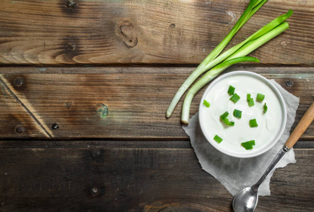 istock Fresh sour cream in bowl with green onions . 1141490753