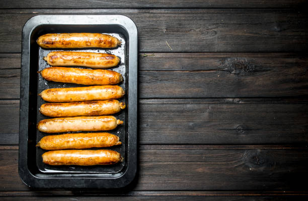 fried sausages on a baking sheet. - 7003 imagens e fotografias de stock