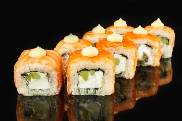 istock Philadelphia roll sushi with salmon, avocado, cream cheese on black background for menu. Japanese food 1141491722