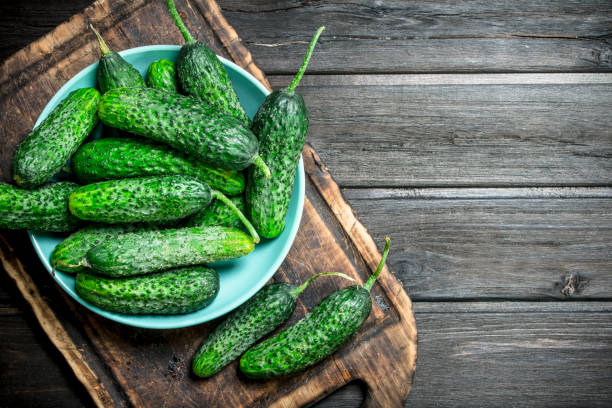 istock Cucumbers in a plate on a cutting Board. 1141491879