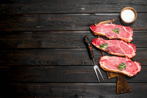 istock Raw beef steaks with salt and spices. 1141492874