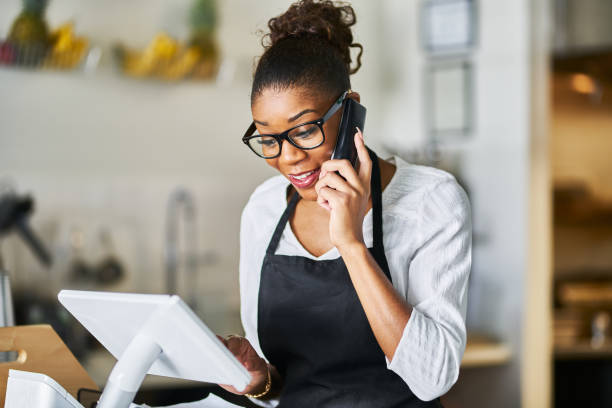 istock waitress in small restaurant taking order over phone onto pos terminal 1141493289