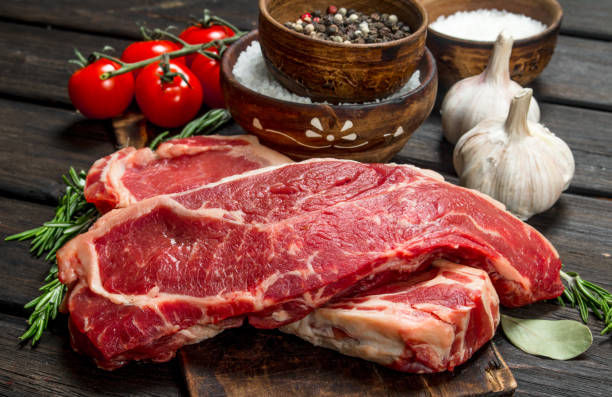 istock Raw beef steaks with salt and spices. 1141493556