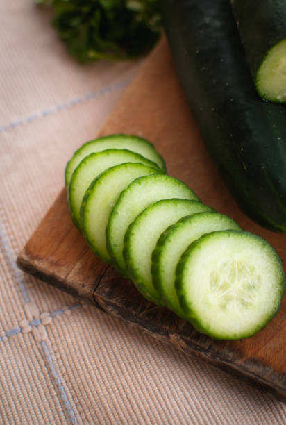 istock Close-up of sliced cucumber on cutting board 1141494046