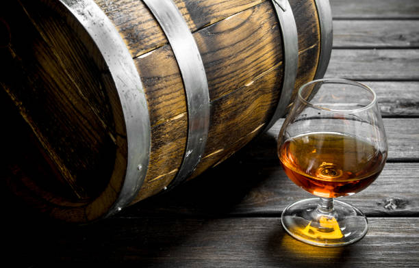 istock Cognac in a glass with a barrel. 1141494296