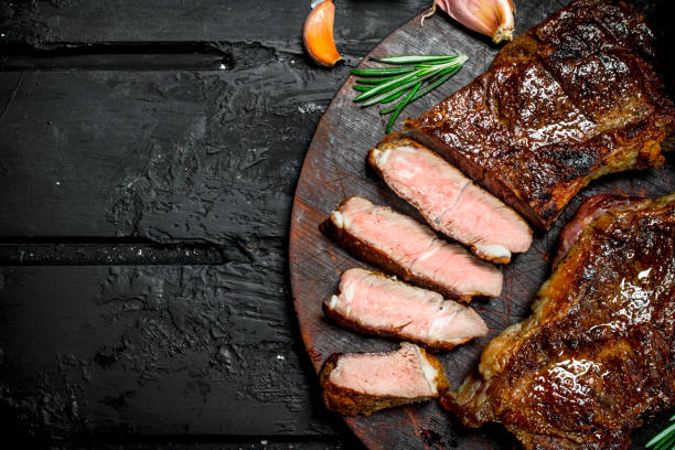 istock Grilled beef steaks with spices and herbs. 1141495249