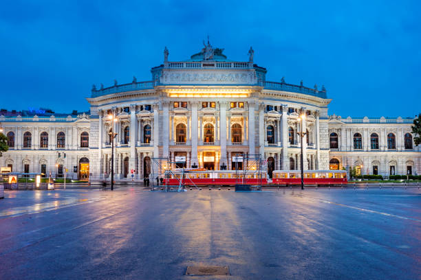Burgtheater on Ringstrasse in downtown Vienna Austria Tram passes in front of the ornate facade of the Burgtheater in downtown Vienna, Austria at twilight. burgtheater vienna stock pictures, royalty-free photos & images