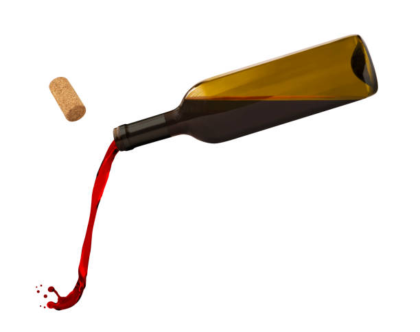 Bottle with flowing red wine Flying bottle with flowing red wine isolated on white background wine glass knocked over stock pictures, royalty-free photos & images