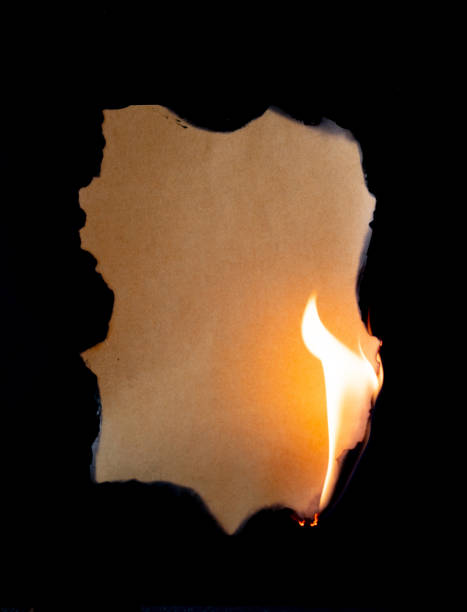 istock burning piece of  paper on black background 1141499136