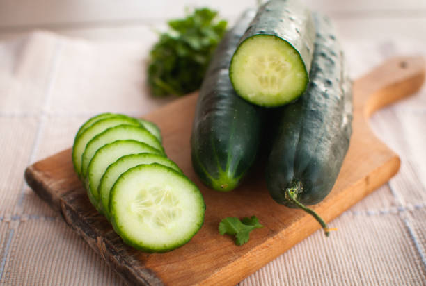 istock Close-up of sliced cucumber on cutting board 1141499191
