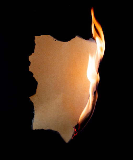 istock burning piece of  paper on black background 1141499209