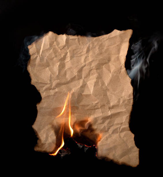 istock burning piece of crumpled paper on black background 1141499263