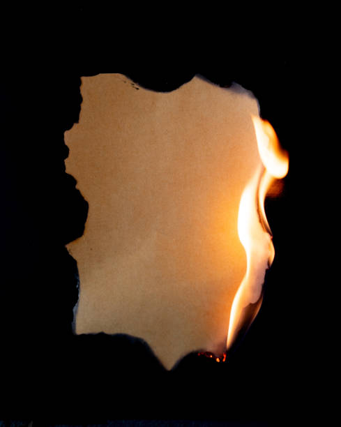 istock burning piece of  paper on black background 1141499273