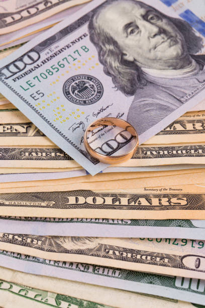 istock Wedding ring lies on the money. 1141499475