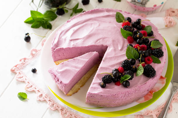 istock Cake with Black Currant Cream, Souffle and Biscuit on the white kitchen table. 1141500900
