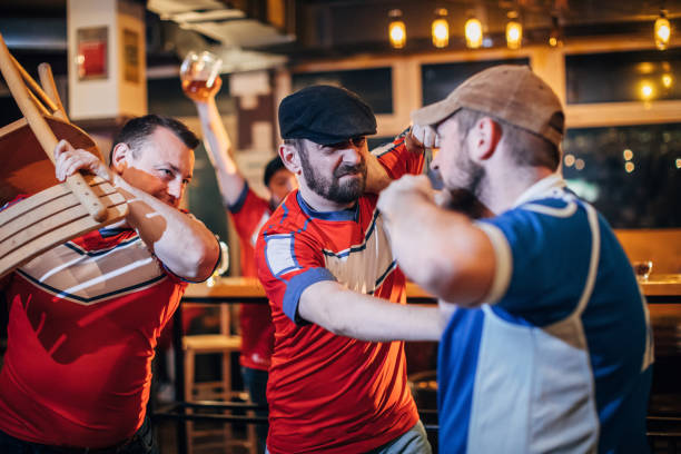 istock Group of fans fighting in pub 1141504143