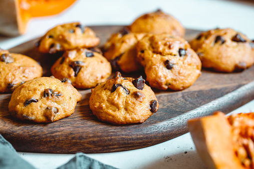 istock Pumpkin cookies with chocolate chips made from cake mix on a wooden tray. 1141506228