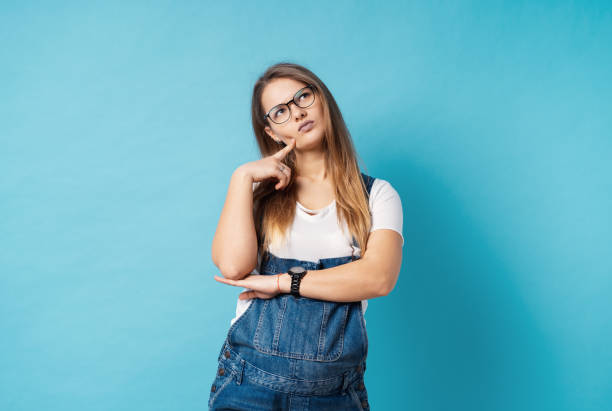 istock A coquette pregnant woman with glasses making a thoughtful face expression 1141508982