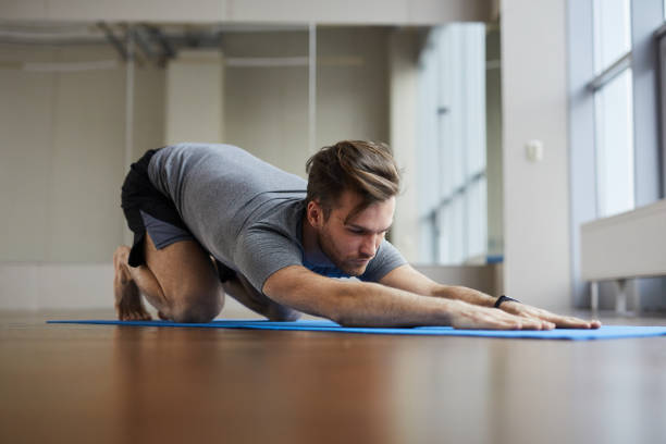 istock Man doing restorative yoga pose 1141511825